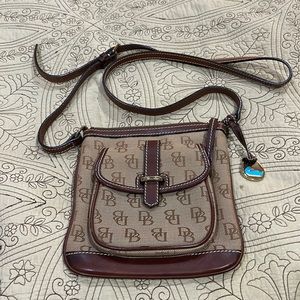 Dooney and Burk small crossbody with front pocket and interior compartments.